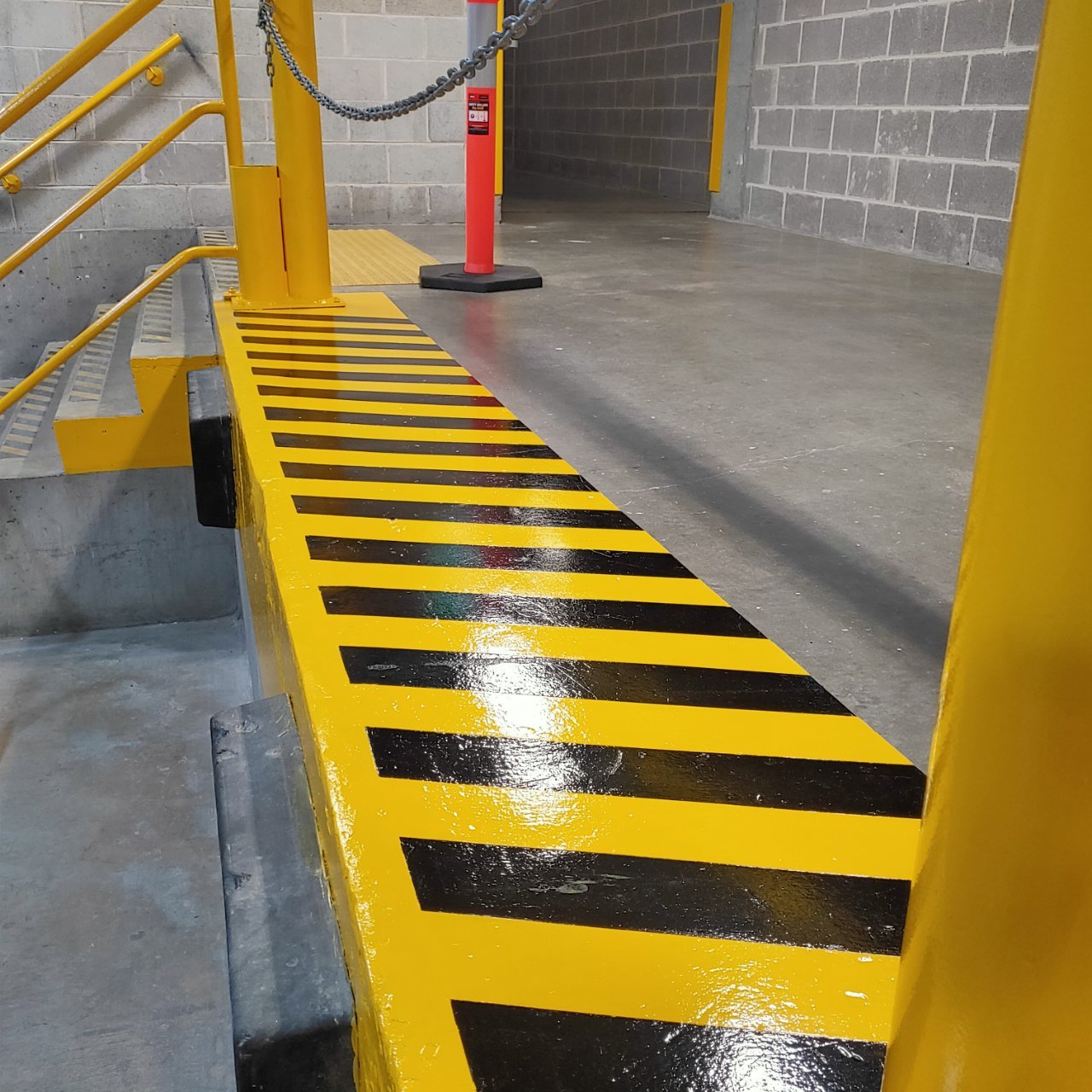 Anti-slip hazard striping to a kerb edge