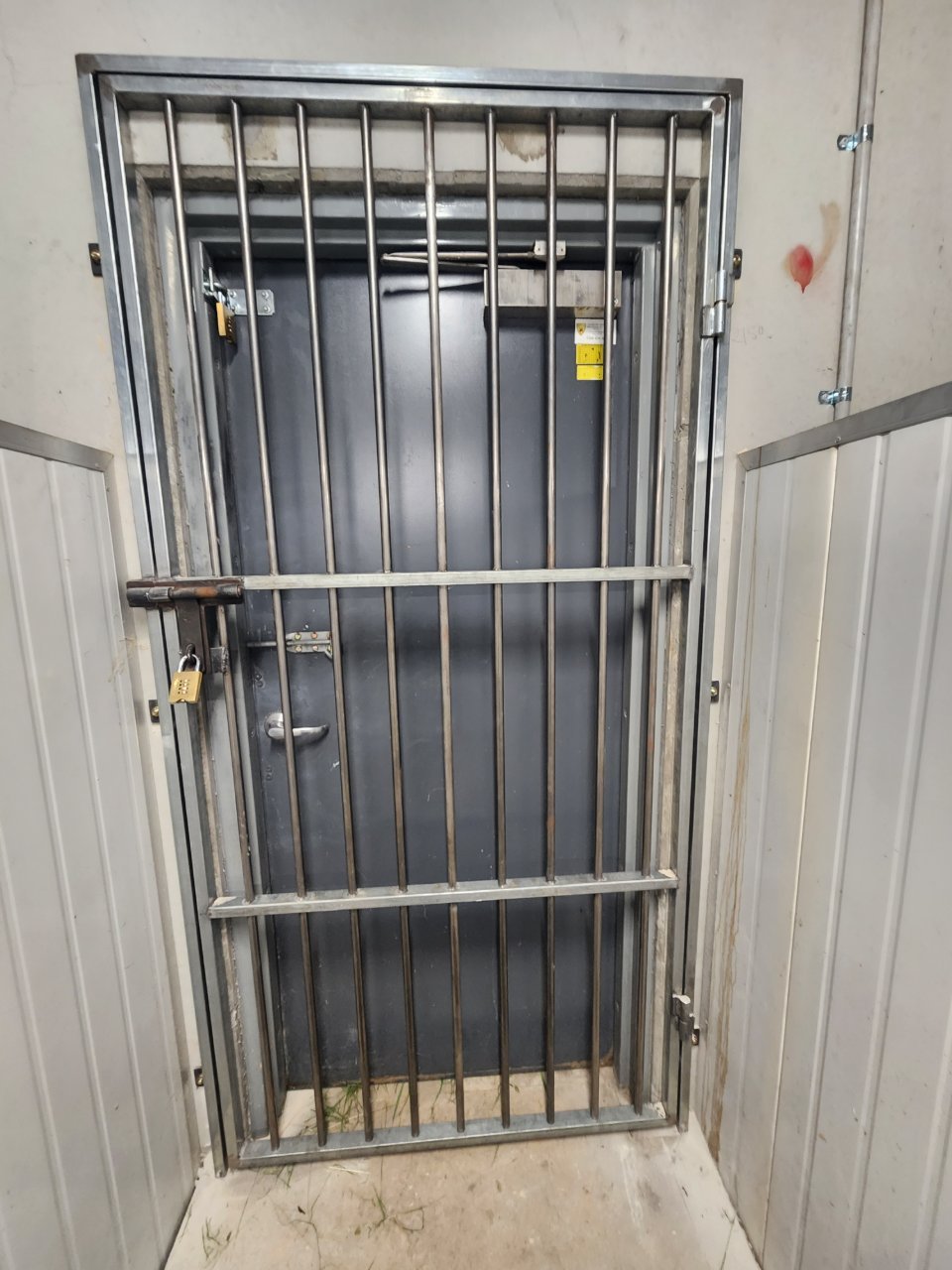 Barred security gate with combination padlock